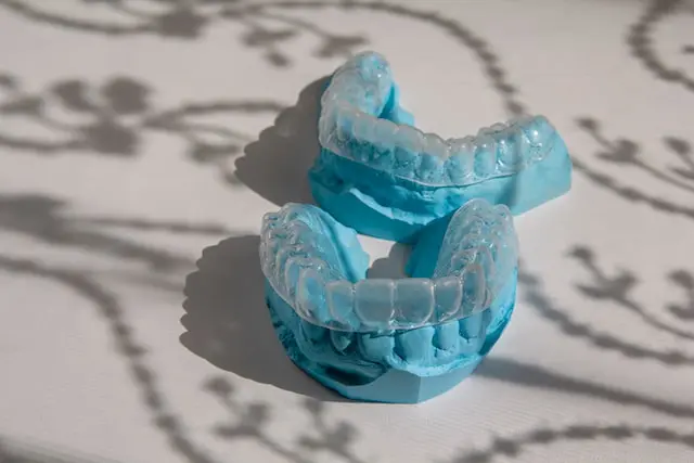 invisalign braces on two blue teeth mockups